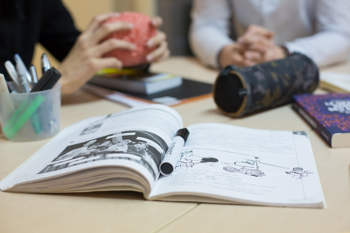 flat ray photography of book, pencil, camera, and with lens